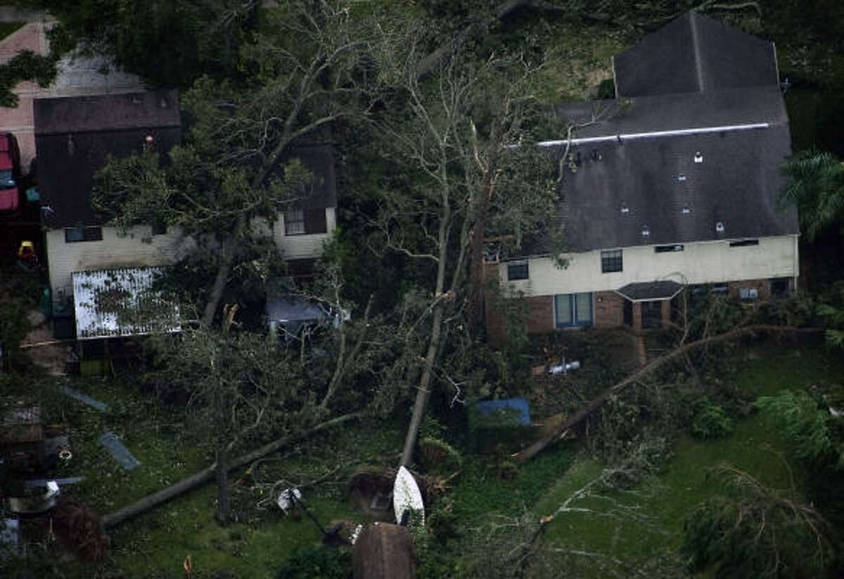Fallen trees are seen against houses after the passing of Hurricane Ike in Seabrook.