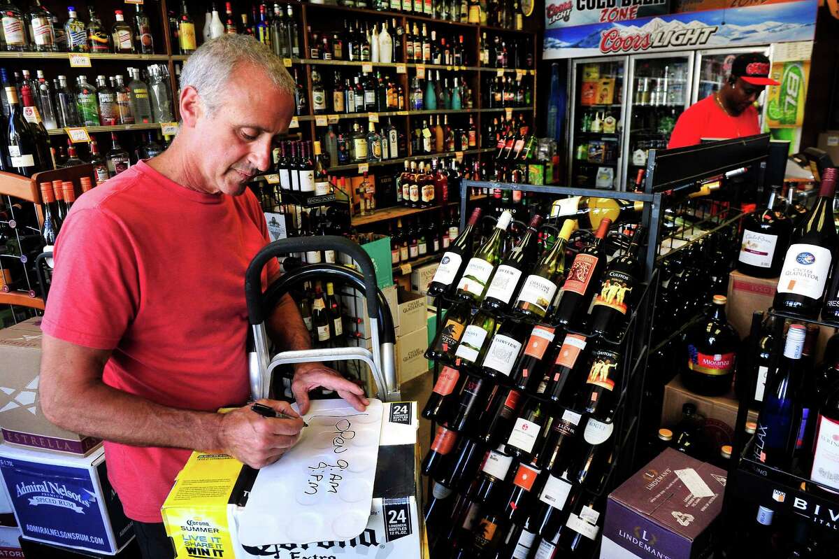 Maurie Samaha has changed the opening time of his store, Danbury Wine & Liquor, from 8 a.m. to 9 a.m., in Danbury, Conn. Tuesday, July 22, 2013.