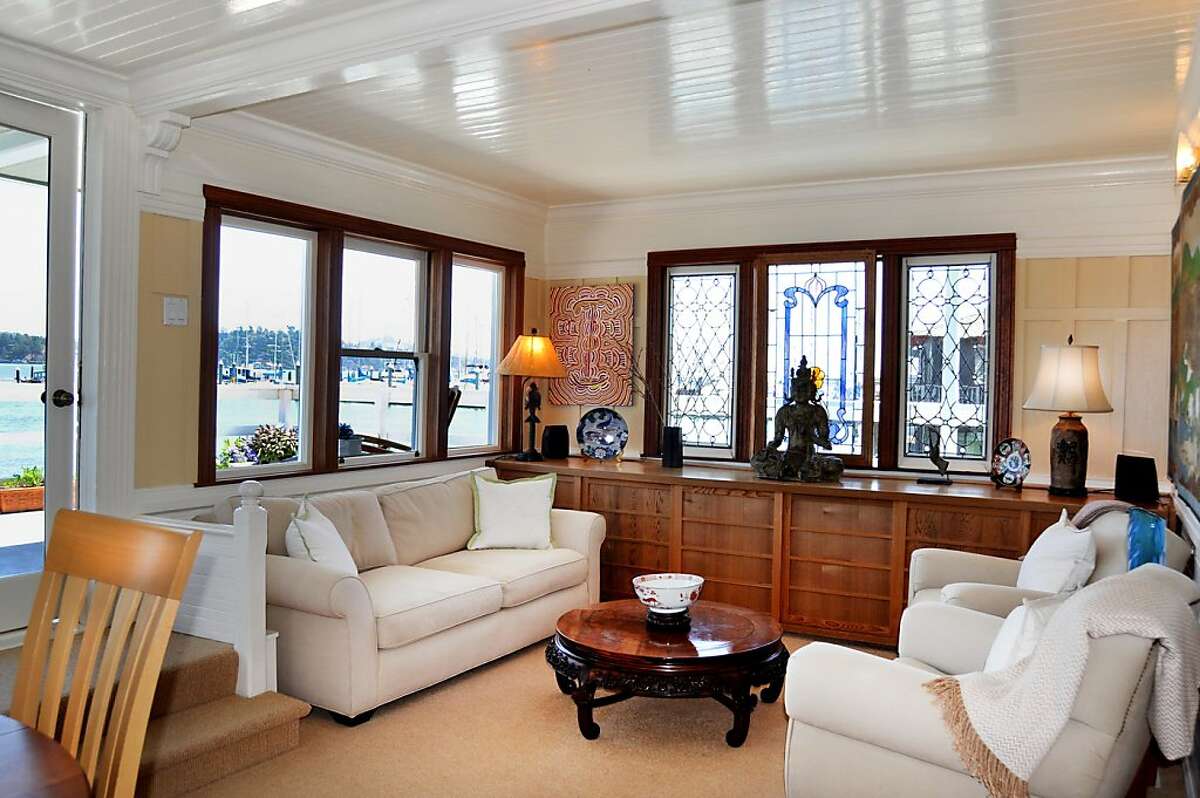 The houseboat has wood-framed windows and stained glass.