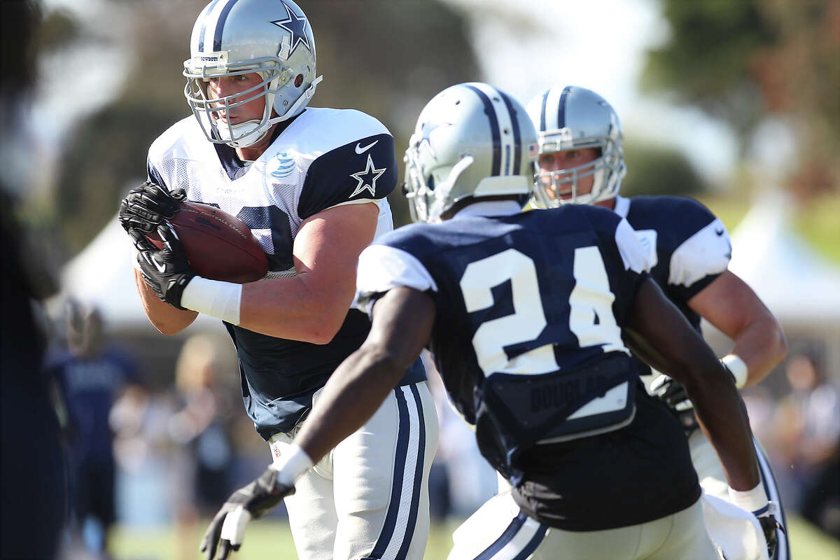 Tight end Jason Witten runs past cornerback Morris Claiborne (24) during the afternoon session of the 2013 Dallas Cowboys training camp on Tuesday, July 23, 2013 in Oxnard.