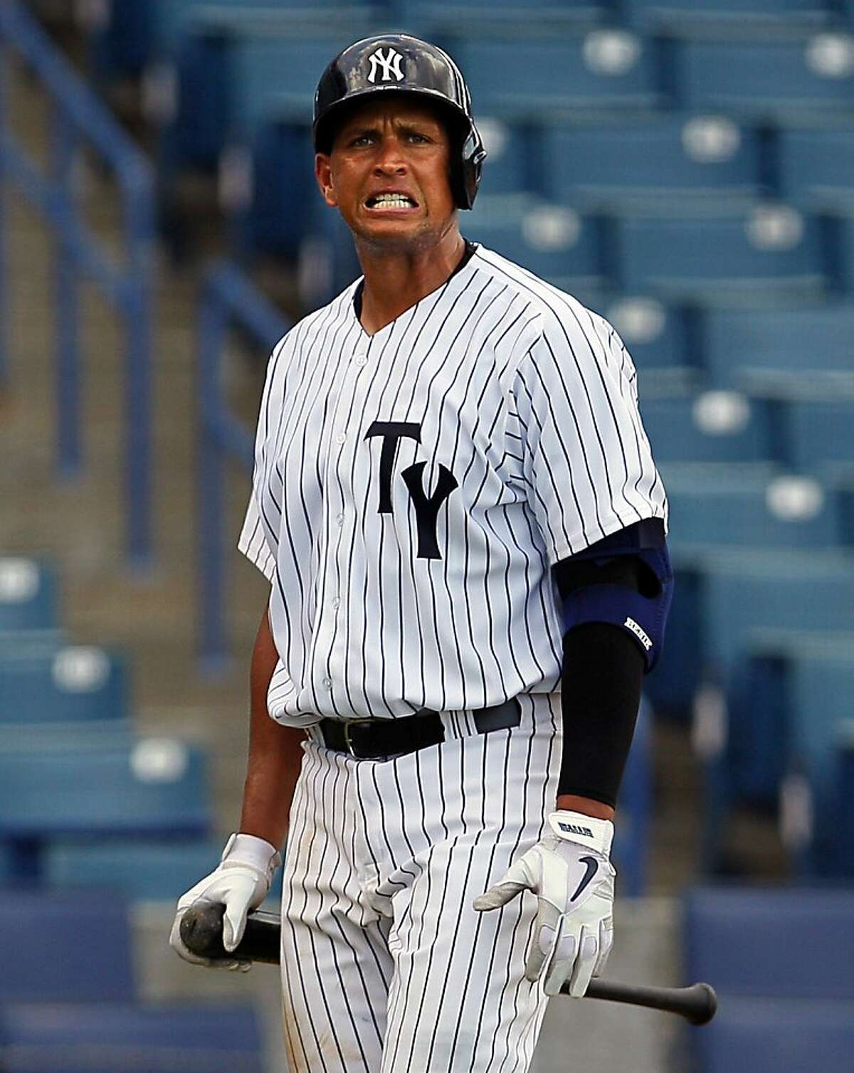 FILE - In this July 9, 2013 file photo, Alex Rodriguez walks back to the bench after striking out in the seventh inning with the Tampa Yankees as they play the Dunedin Blue Jays in Tampa. Much of the focus as baseball heads into the second half is being placed on the possible suspensions of Alex Rodriguez, Ryan Braun and a handful of All-Stars implicated in the Biogenesis performance-enhancing drug scandal. (AP Photo/The Tampa Bay Times, Daniel Wallace) TAMPA OUT; CITRUS COUNTY OUT; PORT CHARLOTTE OUT; BROOKSVILLE HERNANDO OUT; USA TODAY OUT; MAGS OUT