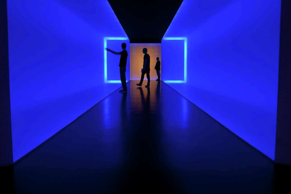 Visitors walk within 'The Light Inside' tunnel by James Turrell at the Museum of Fine Arts, Houston.