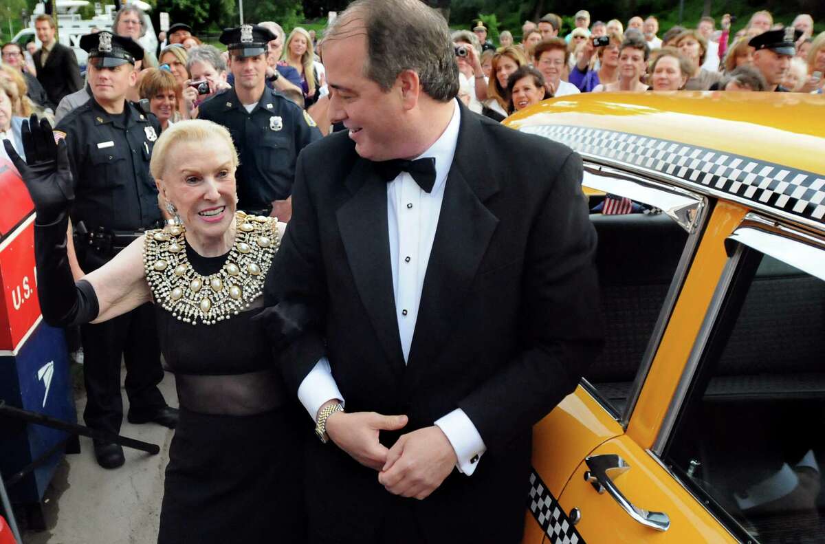 Marylou Whitney, left, waves to her adoring fans as and husband John Hendrickson arrive in a Taxi for the Whitney Gala at the Canfield Casino on Friday, Aug. 6, 2010, in Saratoga Springs, N.Y. This year's theme is Breakfast at Tiffany's. (Cindy Schultz / Times Union)