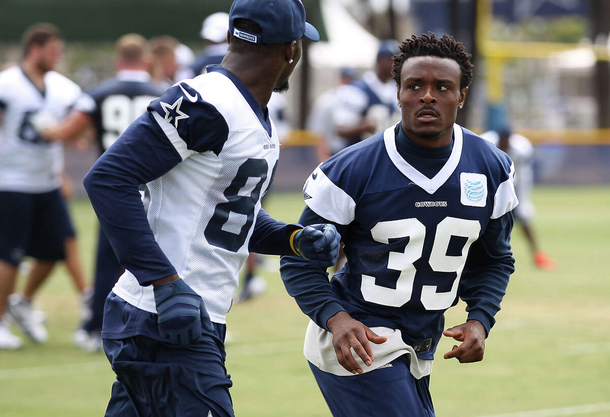 Cornerback Brandon Carr (39) keeps a close eye on receiver Dez Bryant (88) during the morning session of the 2013 Dallas Cowboys training camp on Wednesday, July 24, 2013 in Oxnard.