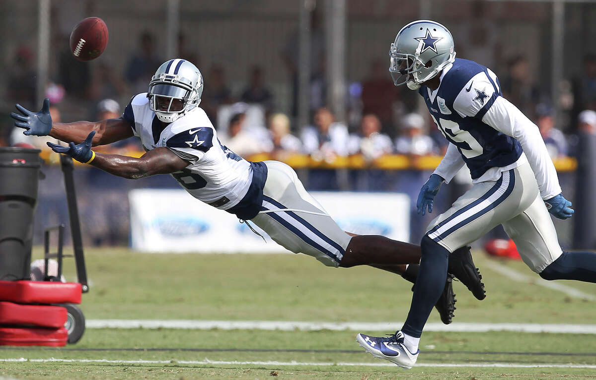 Receiver Dez Bryant dives to attempt a catch against cornerback Brandon Carr (39) during the afternoon session of the 2013 Dallas Cowboys training camp on Wednesday, July 24, 2013 in Oxnard.