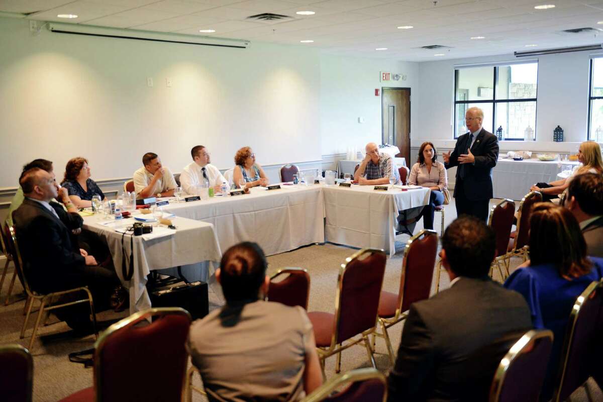 Danbury Mayor Mark Boughton, right, speaks at the Latino and Puerto Rican Affairs Commision meeting at the Portuguese Cultural Center in Danbury, Conn. on Wednesday, July 17, 2013.