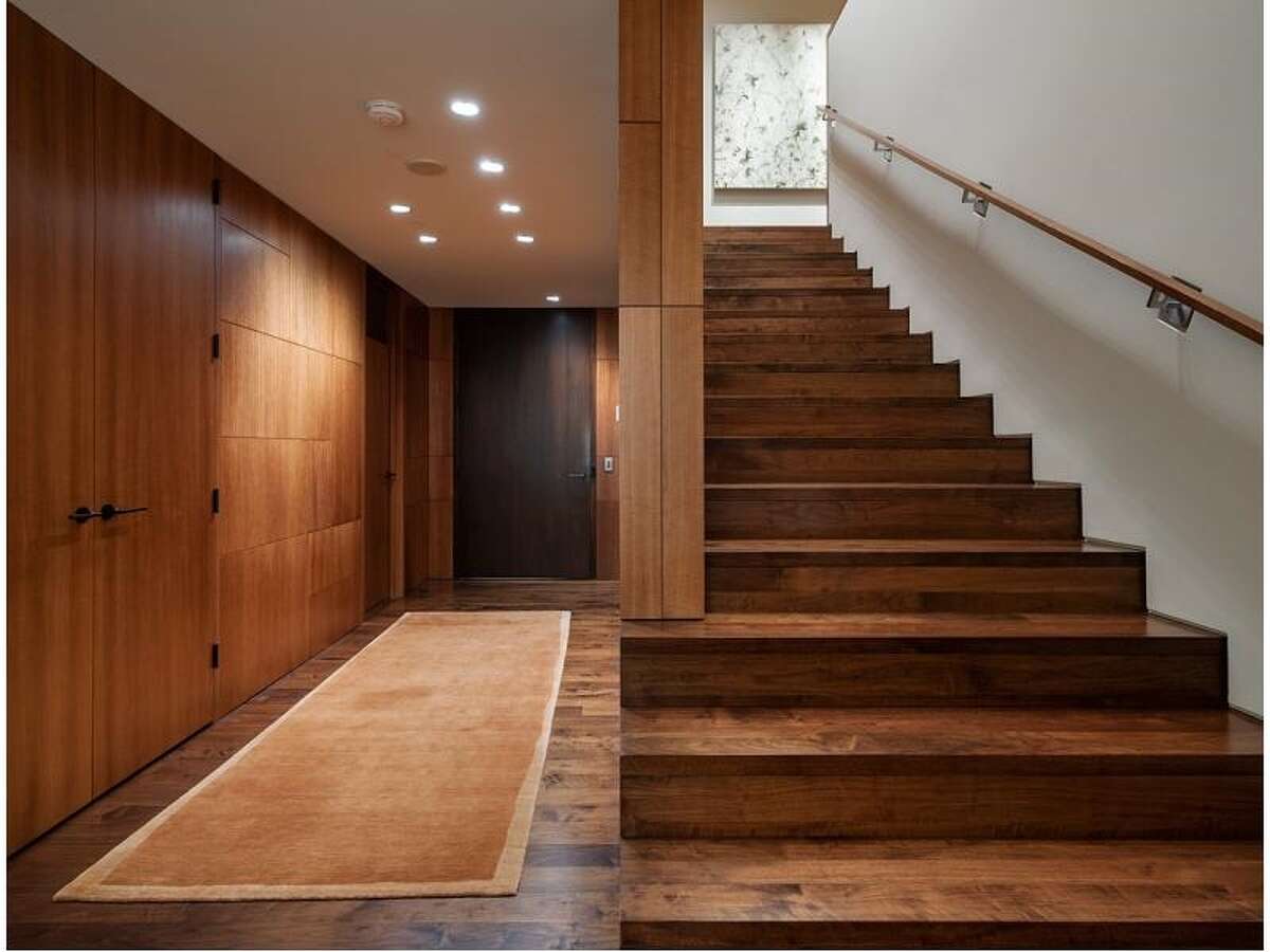 Entry and walnut staircase of 715 2nd Ave., Unit 1504. It's listed for $2.7 million.