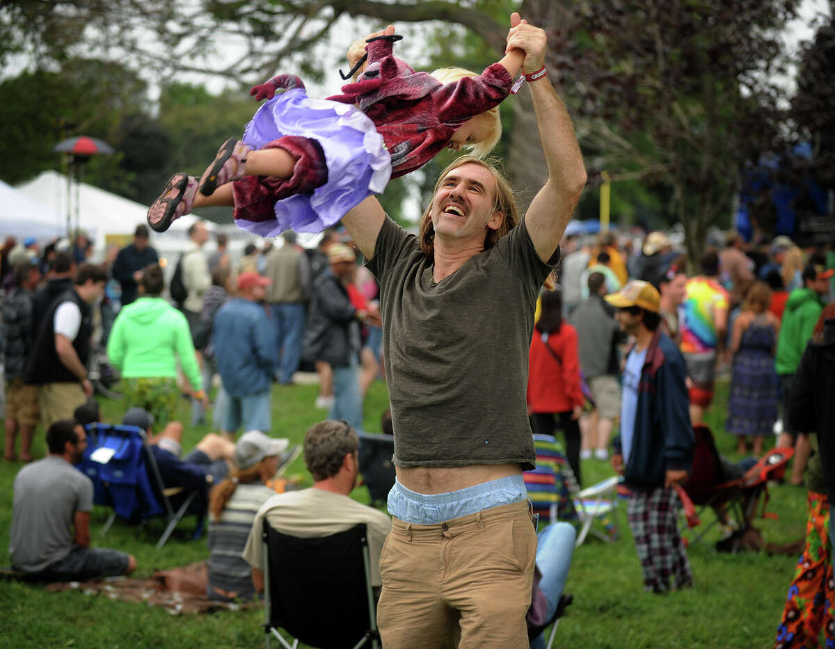 John O'Mara, of Bethel, swings his daughter Redding, 2, into the air at the 18th annual Gathering of the Vibes Musical Festival at Seaside Park in Bridgeport, Conn. on Thursday, July 25, 2013.