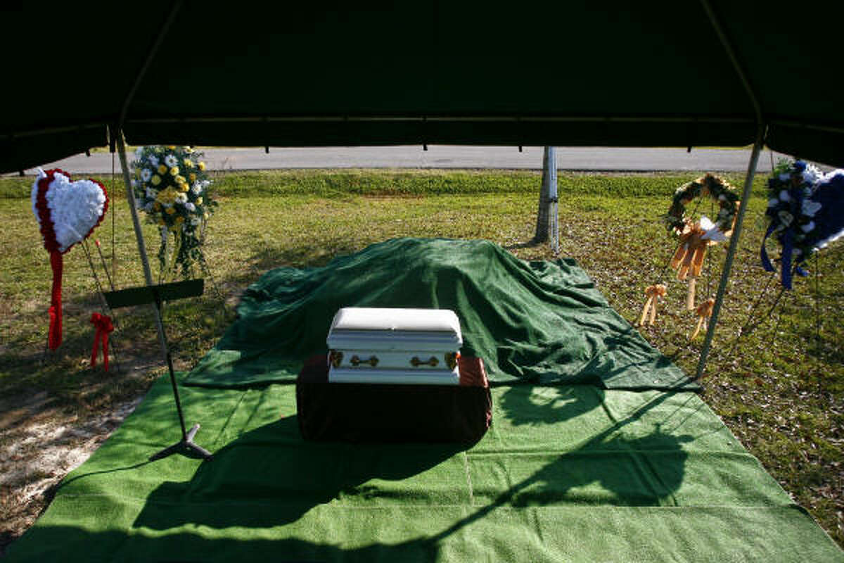 The casket holding the remains of the unidentified victim known as "Swimming Suit Boy" waits to be buried. He was one of 27 young men killed by Corll. Read more about the service.