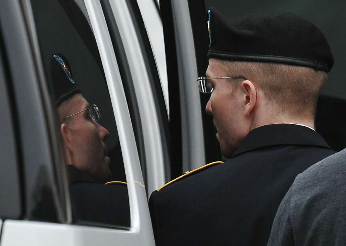 US Army Pfc. Bradley Manning (L) is escorted into court on July 25, 2013 in Fort Meade, Maryland on July 25, 2013. The trial of Manning, accused of "aiding the enemy" by giving secret documents to WikiLeaks, is entering its final stage Thursday as both sides present closing arguments. AFP PHOTO/Mandel NGANMANDEL NGAN/AFP/Getty Images