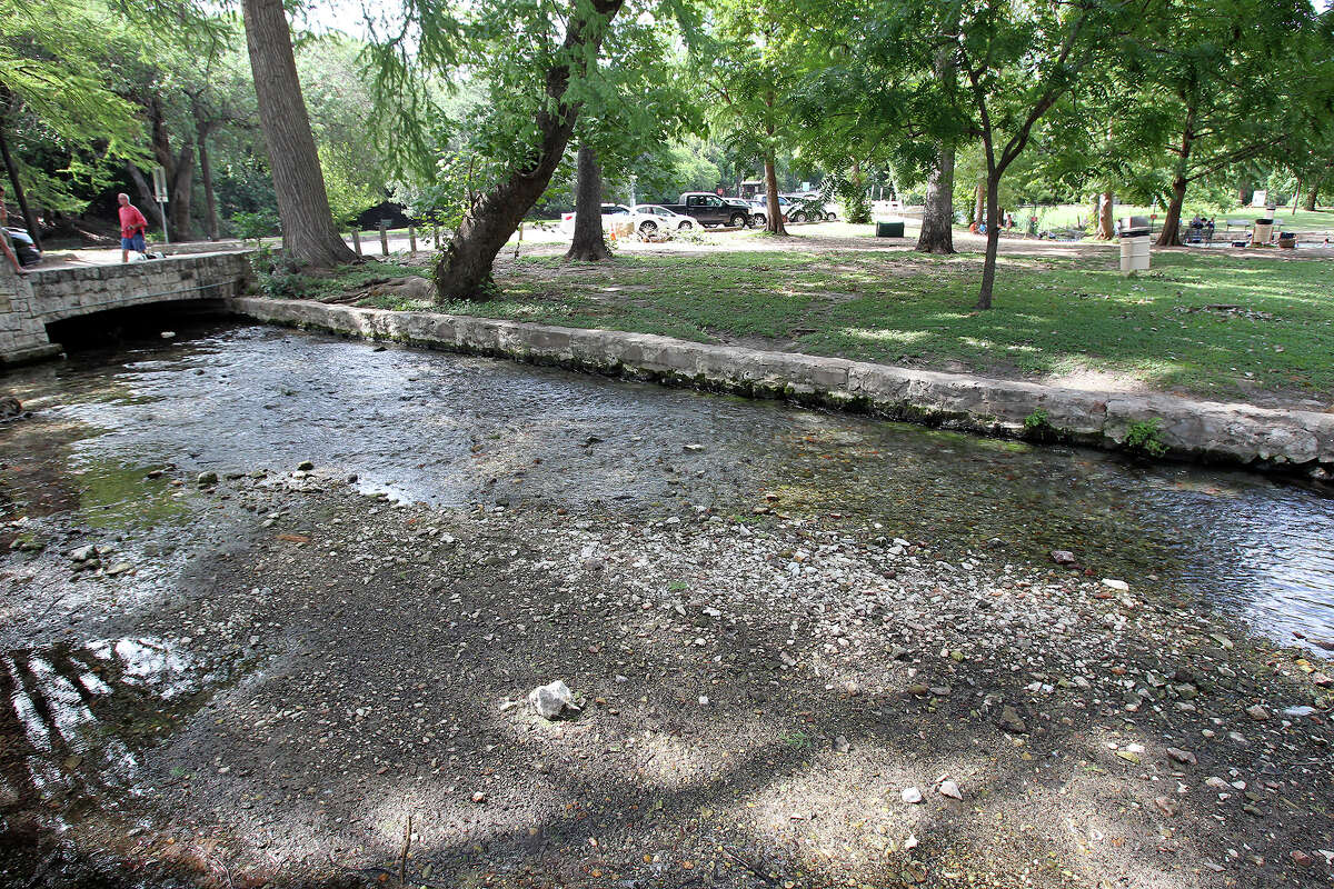 Water flow out of the Comal Springs has slowed noticeably this summer, making rocks visible in the bottom of the waterway leading to Landa Lake on July 25, 2013.