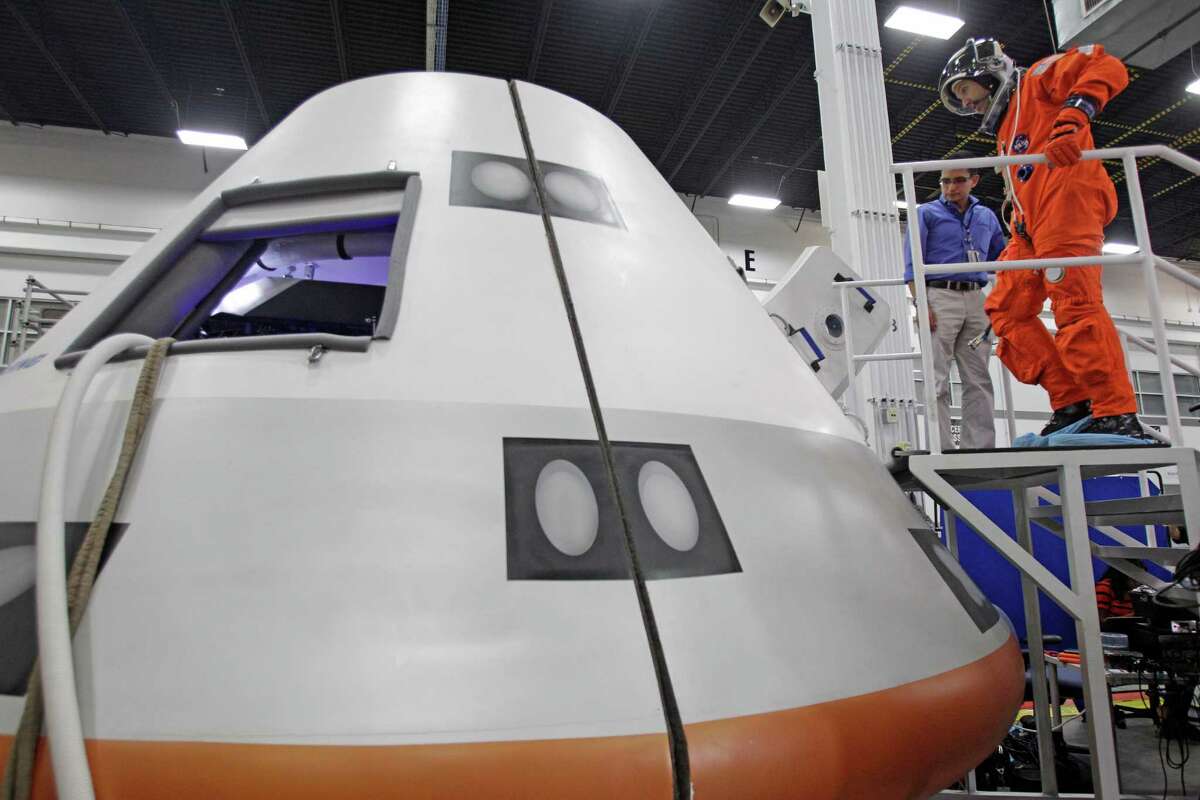 NASA Astronaut Randy Bresnik enters a mock-up of the Boeing CST-100 capsule for a flight suit evaluation at Boeing Houston Product Support Center, 13100 Space Center Boulevard, Monday, July 22, 2013, in Houston. ( Melissa Phillip / Houston Chronicle )