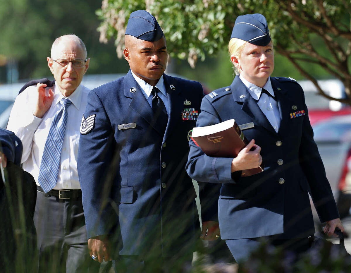 Tech. Sgt. Marc Gayden, center, arrives at Lackland Air Force Base for his trial on sodomy and rape charges, Tuesday, July 23, 2013.
