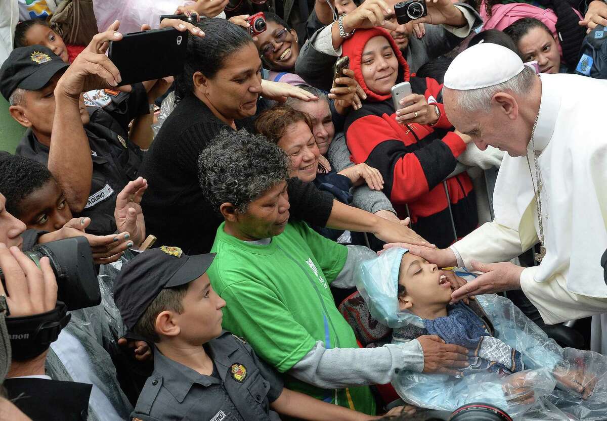 Pope Francis blesses a disabled child during his visit to the Varginha shantytown in Rio de Janeiro.