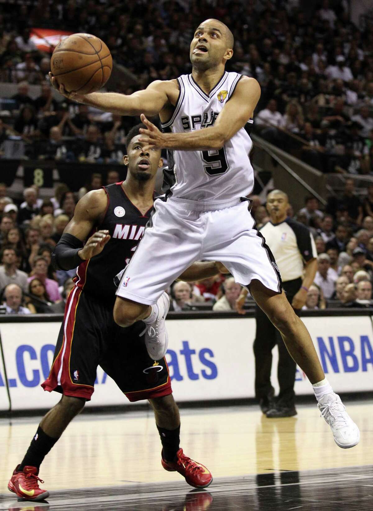 San Antonio Spurs' Tony Parker shoots over Miami Heat's Norris Cole during the first half of Game 5 of the NBA Finals at the AT&T Center on Sunday, June 16, 2013. (Kin Man Hui/San Antonio Express-News)