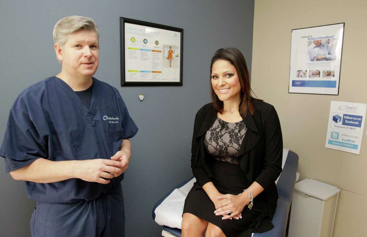 Dr. Erik Wilson confers with patient Ashley Falco during a visit to the UT Health Center. Falco lost 95 pounds after undergoing bariatric surgery in 2011.