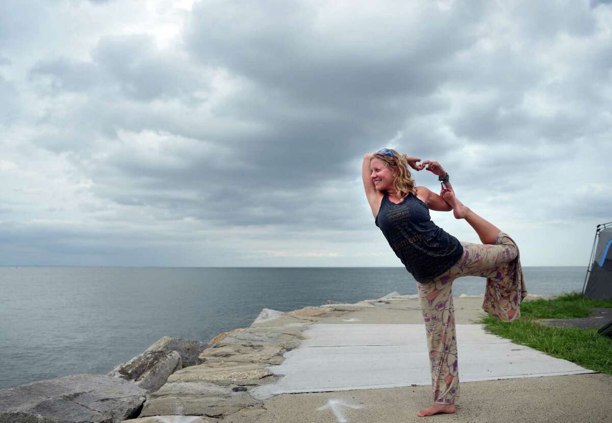 Katie Feinstein faces the Long Island Sound as she practices yoga at the annual Gathering of the Vibes Musical Festival at Seaside Park in Bridgeport, Conn. Friday, July 26, 2013.