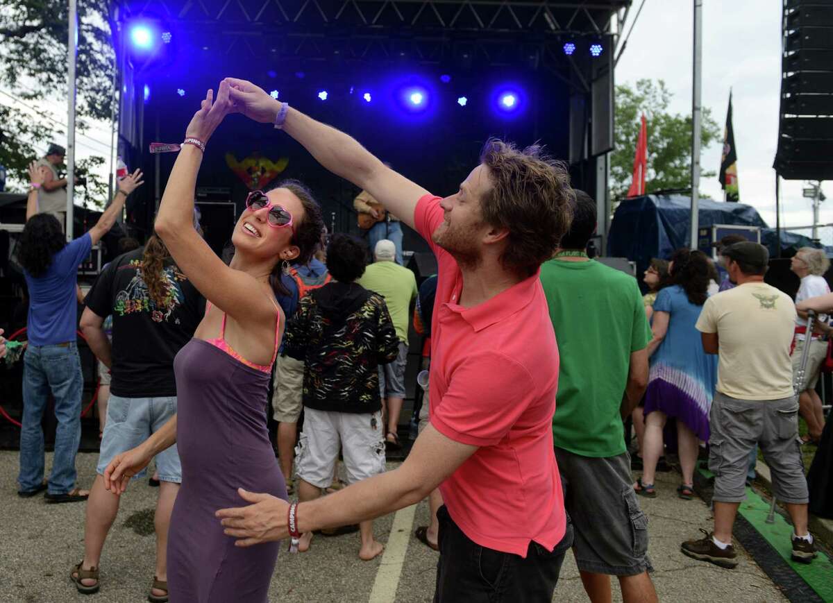 Kera Pesall and Trevor Cape, of Toronto, Ontario, Canada, dance together as David Gans performs on the Green Vibes stage during the 18th annual Gathering of the Vibes Musical Festival at Seaside Park in Bridgeport, Conn. Friday, July 26, 2013.