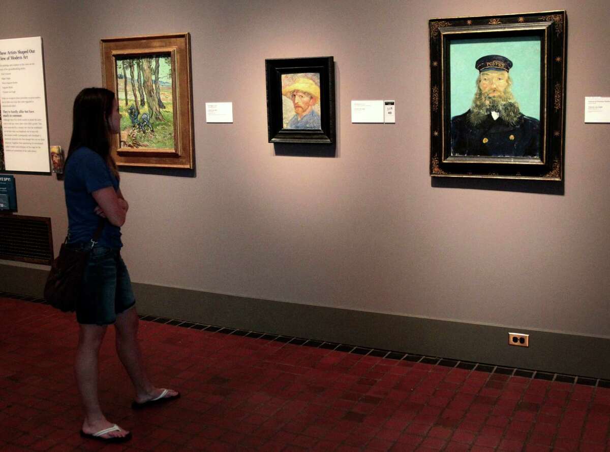 A visitor views a wall of paintings by Vincent Van Gogh displayed at The Detroit Institute of Arts in Detroit, Michigan, U.S., on Friday, July 19, 2013. Detroit, the cradle of the automobile assembly line and a symbol of industrial might, filed the biggest U.S. municipal bankruptcy after decades of decline left it too poor to pay billions of dollars owed bondholders, retired cops and current city workers. Photographer: Jeff Kowalsky/Bloomberg