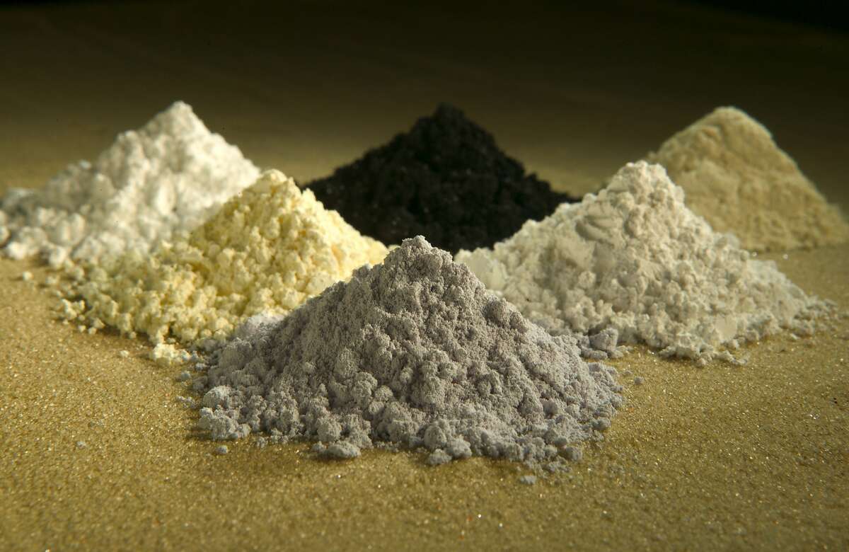 In this undated photo released by the U.S. Department of Agriculture are rare-earth oxides, clockwise from top center: praseodymium, cerium, lanthanum, neodymium, samarium, and gadolinium. Across the West, early miners digging for gold, silver and copper had no idea that one day something even more valuable would be hidden in the piles of dirt and rocks they tossed aside. Now there's a rush in the U.S. to find key components of cellphones, televisions, weapons systems, wind turbines, MRI machines and the regenerative brakes in hybrid cars, a group of versatile minerals on the periodic table called rare earth elements and old mining tailings piles just might be the answer. (AP Photo/U.S. Department of Agriculture, Peggy Greb)