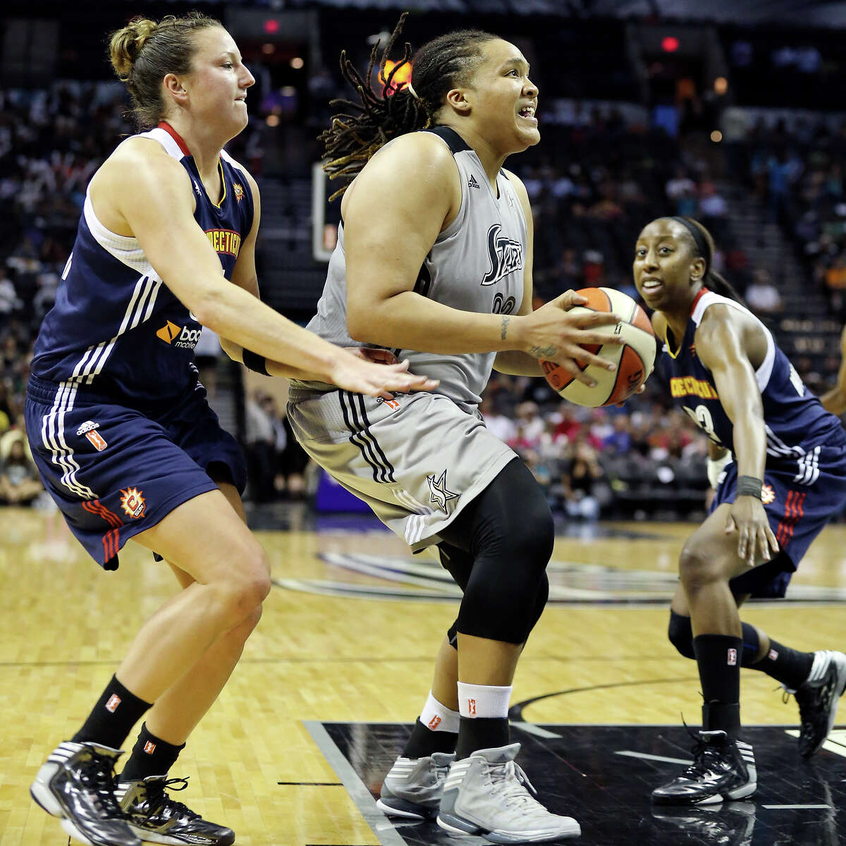 Silver Stars' drives to the basket between Sun's Kelsey Griffin (left) and Allison Hightower during second half action Saturday July 20, 2012 at the AT&T Center. The Silver Stars won 60-52.