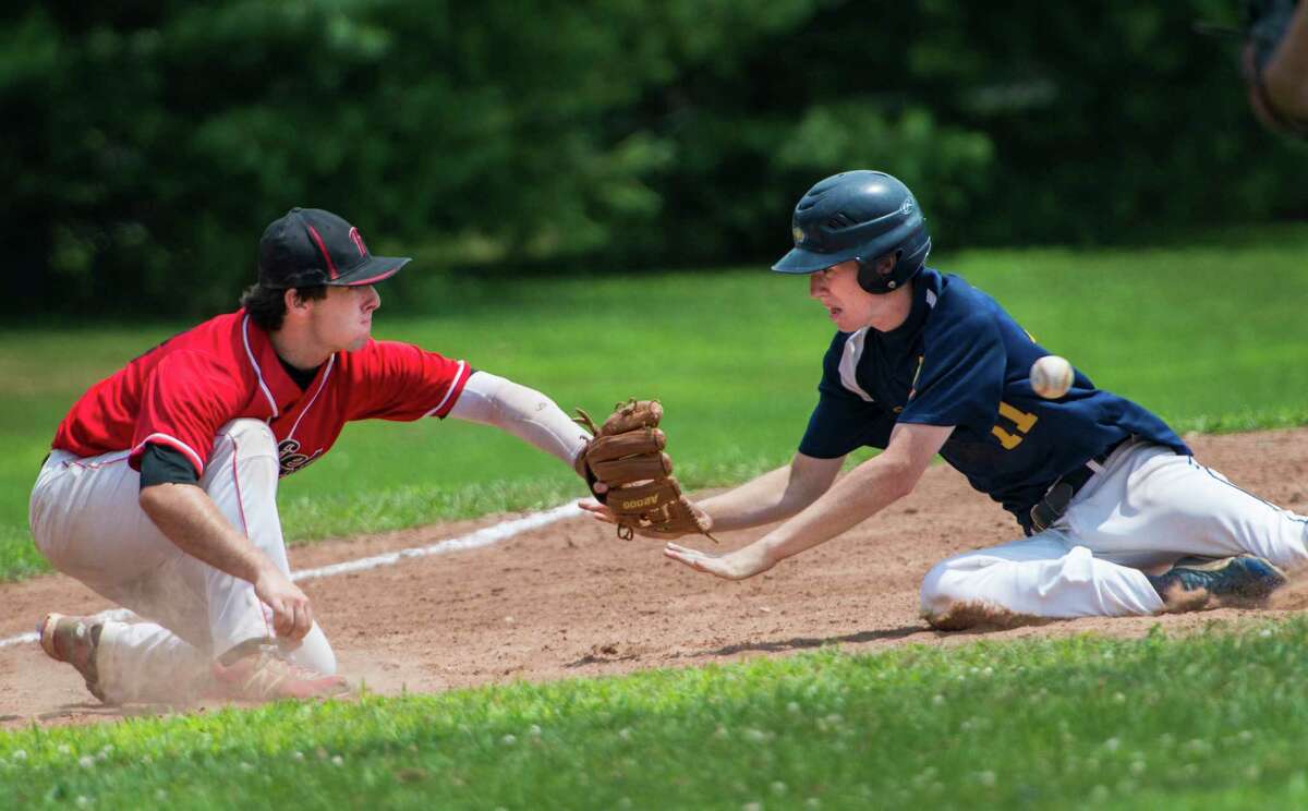 Fairfield third baseman John Carroll doesn't get the ball in time to tag Danbury's Cooper Yusko out so Yusko slides safely into third base during a Connecticut Junior Legion sectional baseball game played at Owen Fish Park, Fairfield, CT on Saturday July 27th, 2013.