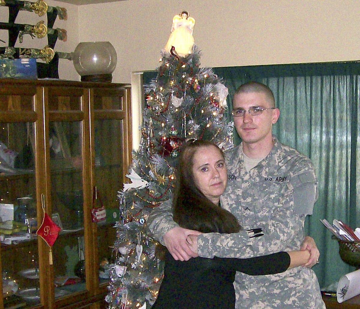 Michael Pearson poses with his mother, Sheryll Pearson, in 2008, during the last Christmas he would spend with his family. “He was the most exciting kid ever in the whole world,” she said.