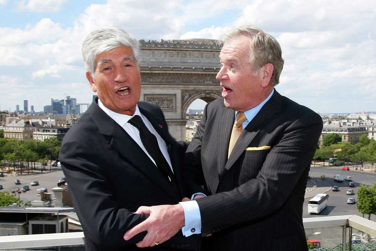 Maurice Levy, left, Chief Executive of French advertising group Publicis, and John Wren, head of Omnicom Group pose during a joint news conference in Paris, France, Sunday, July 28, 2013. Publicis and Omnicom have announced merger plans to create the world's biggest advertising group (AP Photo/Francois Mori)