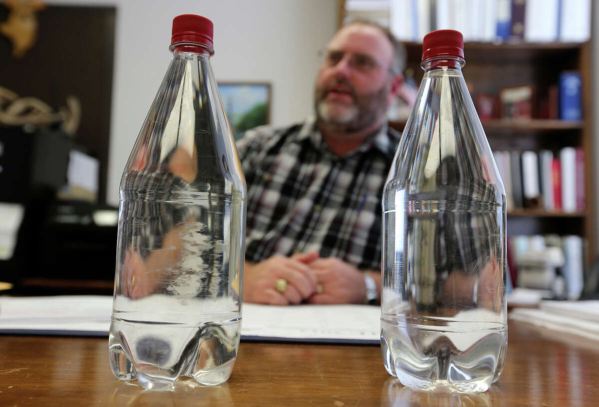 David Harris, the city of Brownwood’s utilities director, shows bottles of treated sewage (left) and regular tap water.