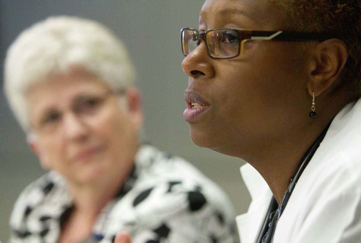 Karen Walters, left, a registered nurse, listens to Andrea Downey, a nurse practitioner, last week during Schwartz Center Rounds at Houston Methodist Hospital, where caregivers discuss job issues.