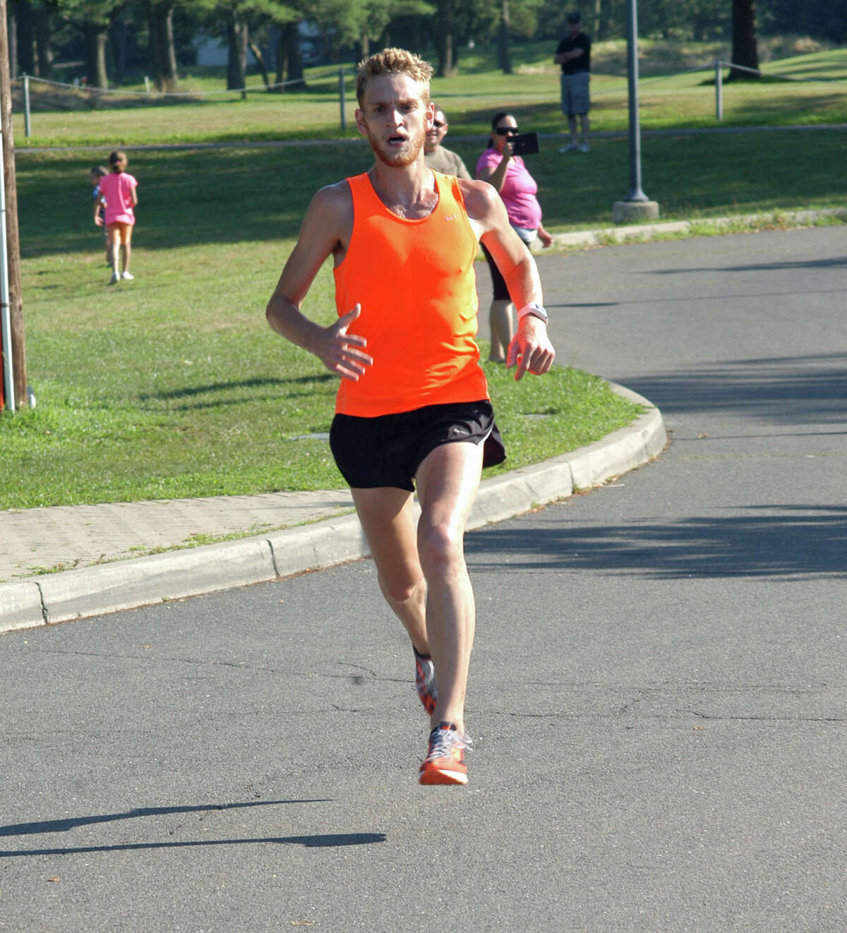 Luke McCambley, 23, of New York, races to a first-place finish at the Westport Road Runners Series 4.7-miler on Saturday. McCambley finished the course at Longshore Country Club in 25:41 for his fourth straight win.