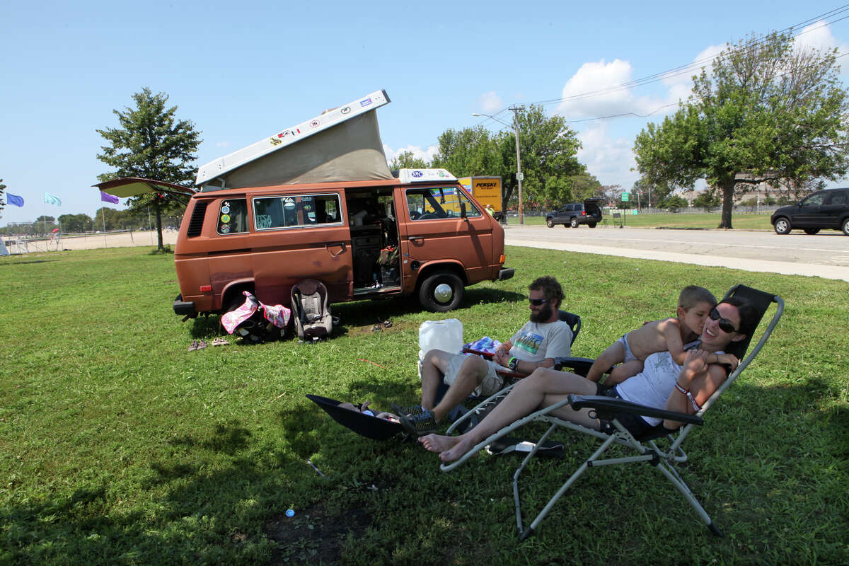 After a weekend at the Vibes, Casey Zawicki, left, of Cape Cod, and Lindsay Cook, and their two children, Orin, 5, and Ilea, 9 weeks, wait for auto help by their broken down van in Seaside Park in Bridgeport on Monday, July 29, 2013.