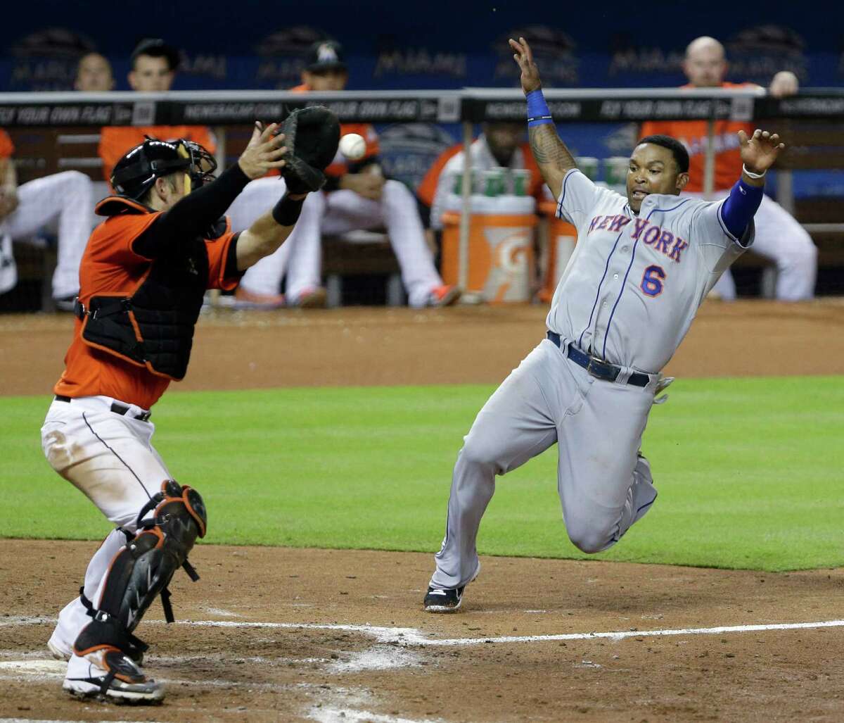 New York Mets' David Wright, center, slides into third base after