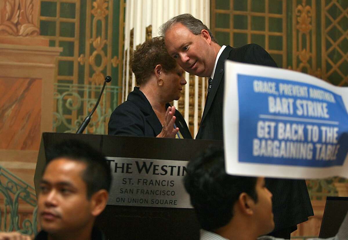 BART general manager Grace Crunican (top left) talks with the president and CEO of APTA Michael P. Melaniphy as BART union members protest during her presentation at the 2013 American Public Transportation Association Sustainability and Public Transportation workshop at the Westin St. Francis Hotel in San Francisco, Calif., on Monday, July 29, 2013.