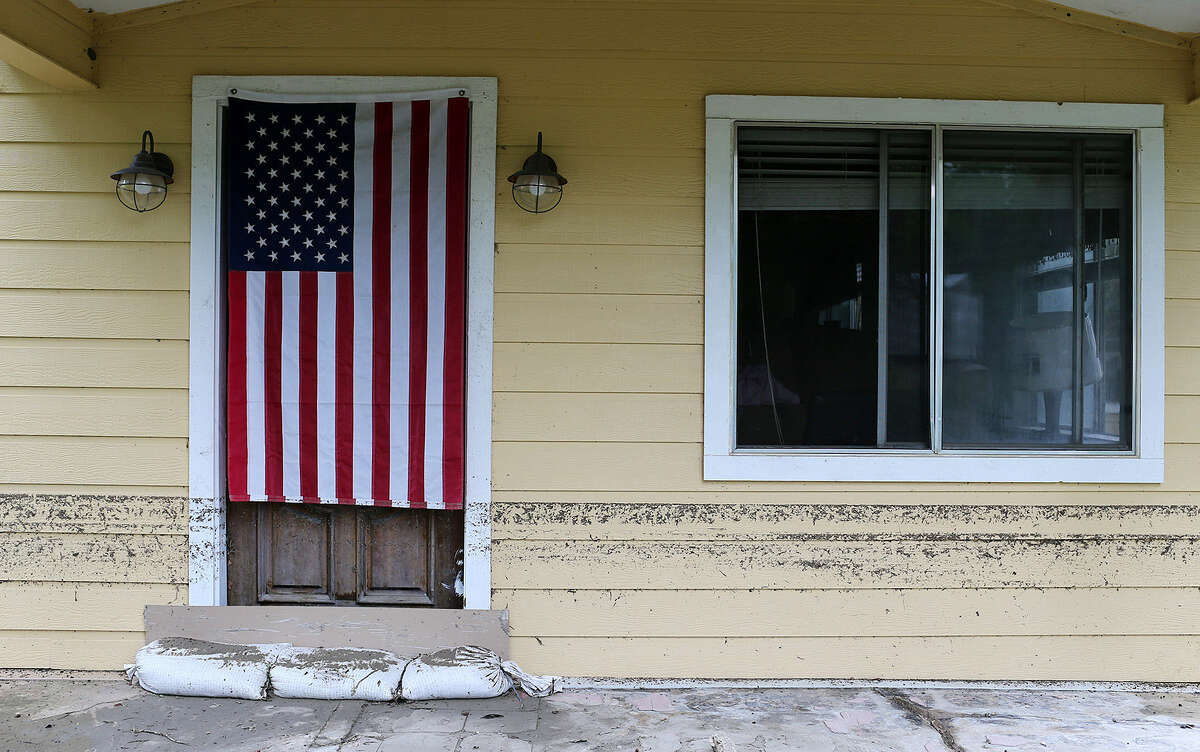 A water line registered the height of flood waters on a house along Mission Road on May 26. An E-N reader wonders what the expense will be to repair damage caused by flooding in May, and how it will affect homeowners and taxpayers.