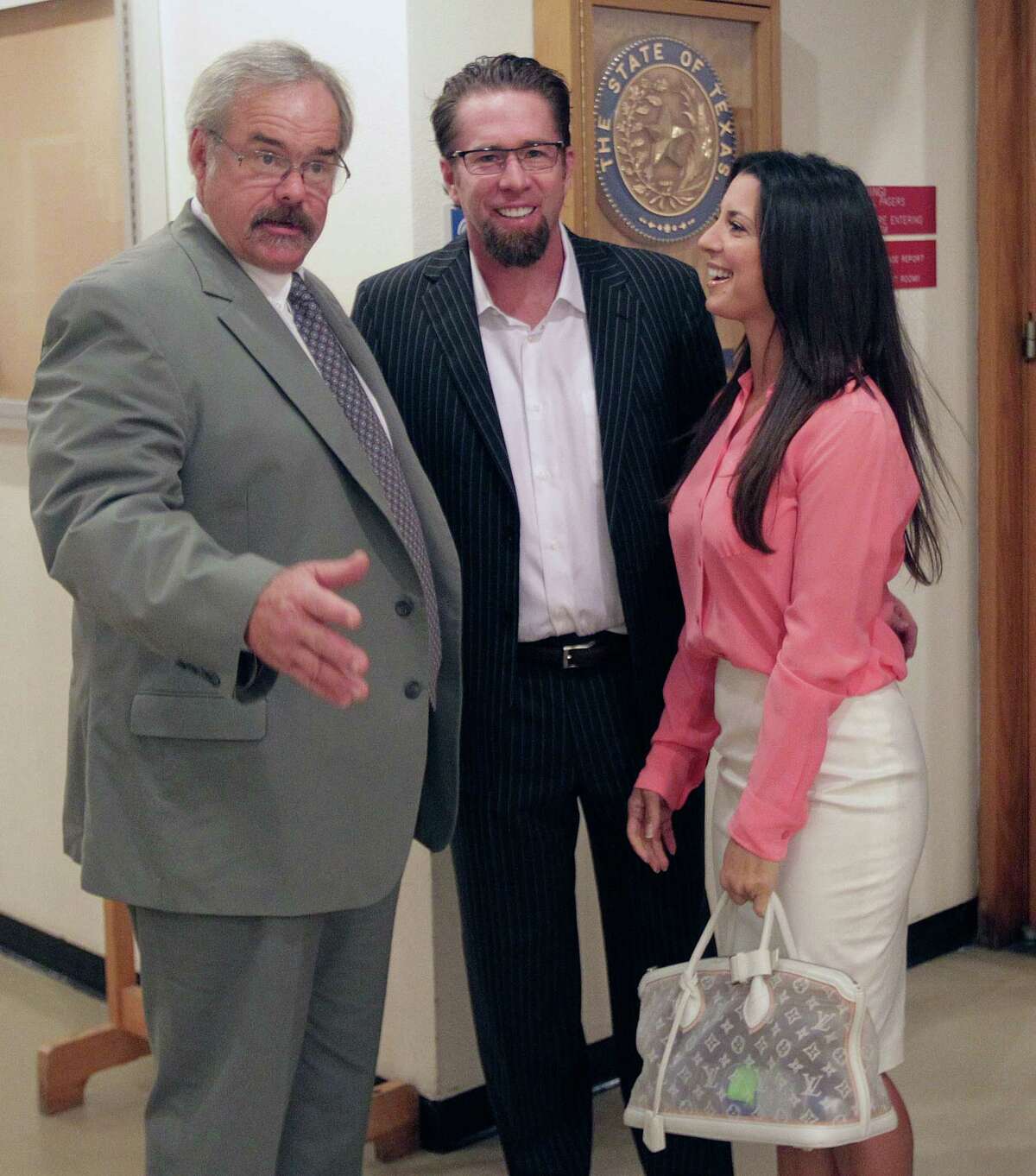 Rachael Brown, Jeff Bagwell, center, and Brown's attorney David Brown exit the courtroom before a hearing on a contempt-of-court order for former hand surgeon and Rachael Brown's ex-husband Michael Brown in the 309th Family Court, July 30, 2013, in Houston. ( James Nielsen / Houston Chronicle )