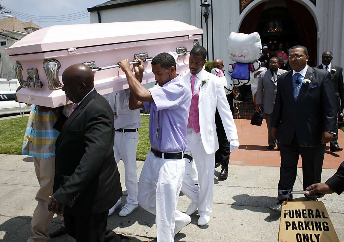 The pallbearers carry the casket of Alaysha Carradine to the hearse, Tuesday July 30, 2013, at the McNary-Williams-Jackson Mortuary in Oakland, Calif. Alaysha, 8, was shot and killed when a gunman opened fire through the door of a friend's house.