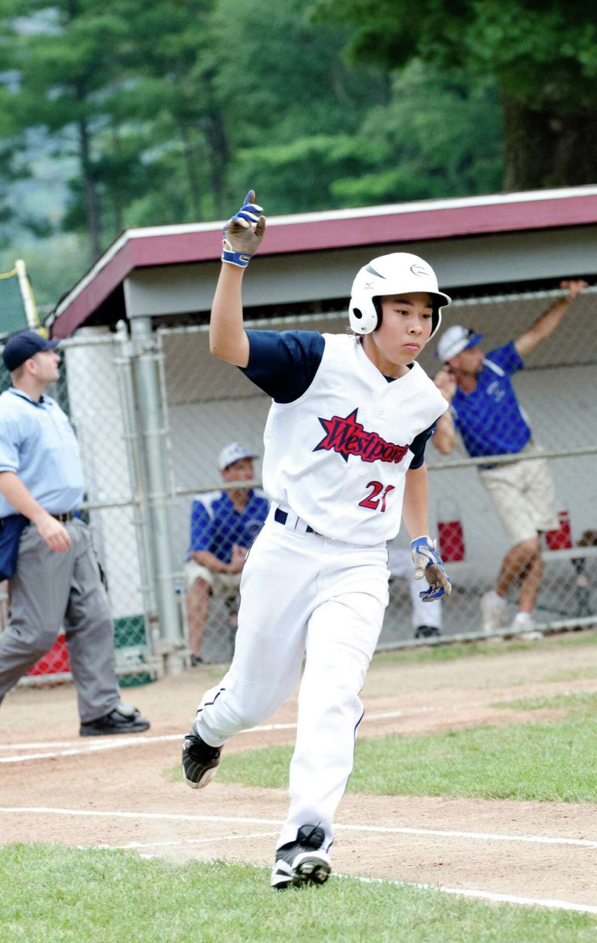 Westport's Chad Knight puts his hand in the air as he takes a victory lap around the bases during the 12-year-old Little League baseball state finals against Coginchaug at Southington South Little League at Recreation Park on Maxwell Noble Drive in Plantsville on Sunday, July 28, 2013.