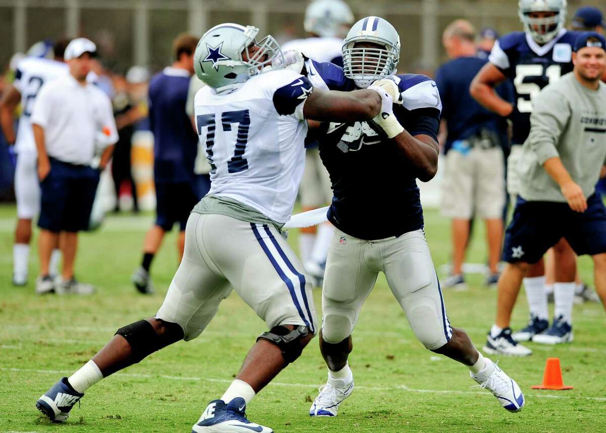 Third-year offensive tackle Tyron Smith (77) continues to improve, largely as a result of daily clashes with seven-time Pro Bowler DeMarcus Ware.