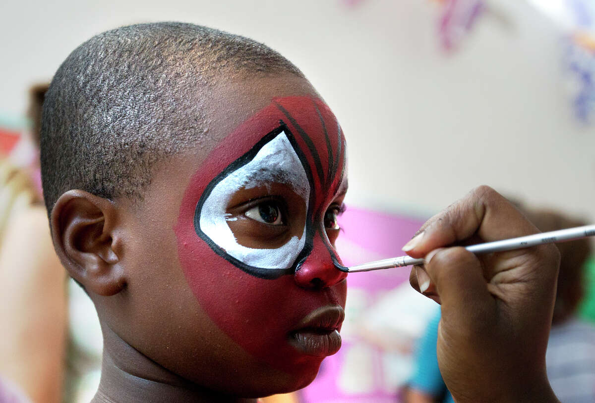 Chika Aniekwu, 6, gets his face painted during the event at the museum. There are plenty of games, hands-on activities and fun challenges featuring superheroes.