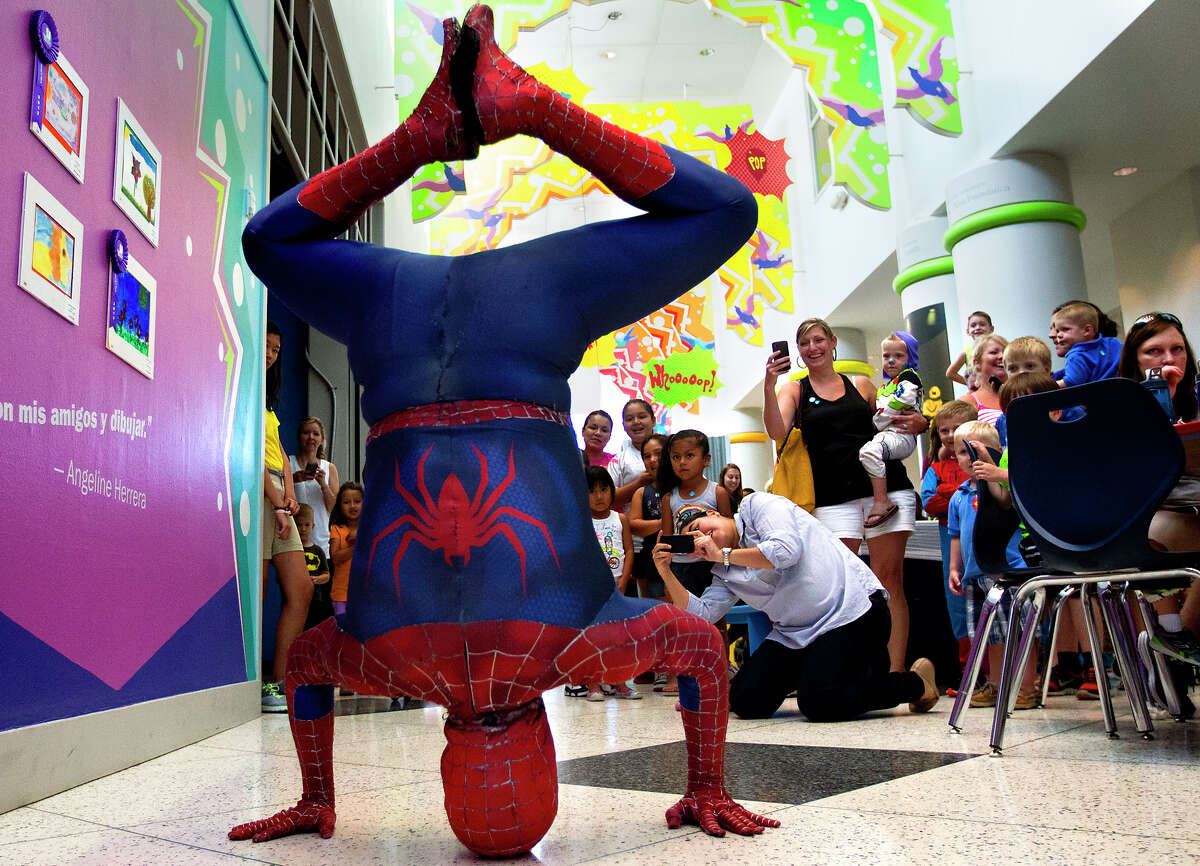 Spider-Man shows off his skills Thursday during Spider-Man Day at the Children's Museum of Houston.