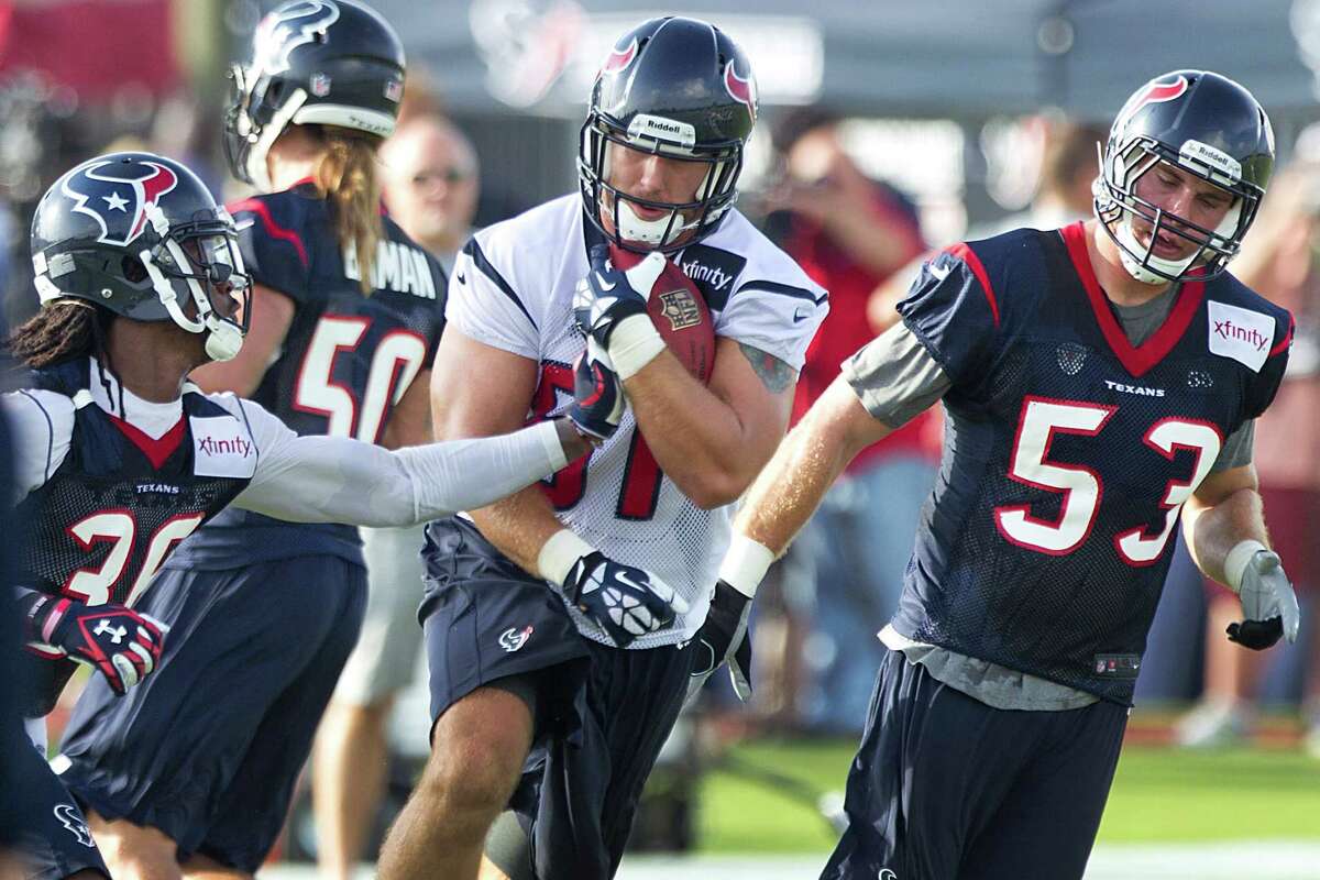 Houston Texans tight end Owen Daniels (81) runs between safety D.J. Swearinger (36) and linebacker Mike Mohamed (53) during Texans training camp at the Methodist Training Center Friday, July 26, 2013, in Houston. ( Brett Coomer / Houston Chronicle )