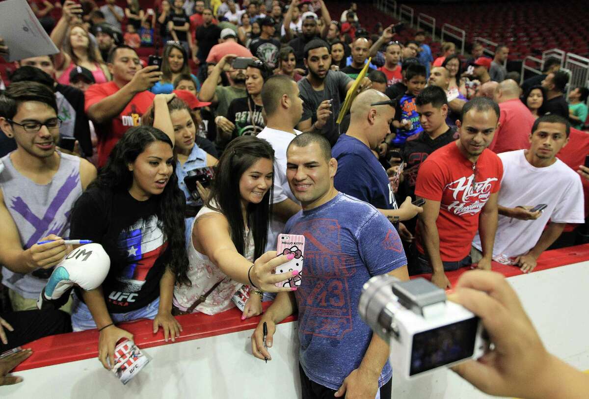 Cain Velasquez had plenty of requests for photos and autographs during Thursday's promotional event at Toyota Center for UFC 166.