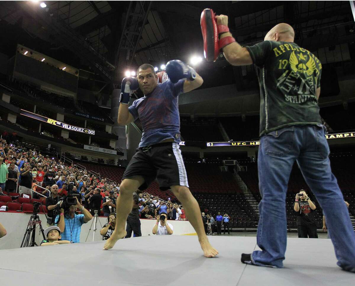 Cain Velasquez, left, and trainer Bob Cook put on an exhibition for fans Thursday at Toyota Center.