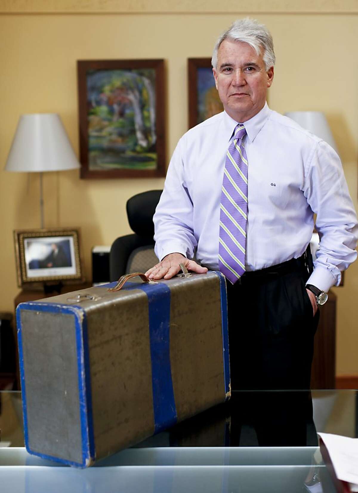 San Francisco District Attorney George Gascon is seen on Friday, March 22, 2013 at the Hall of Justice in San Francisco, Calif., with the suitcase that his family had when they fled Cuba in the 1960's.