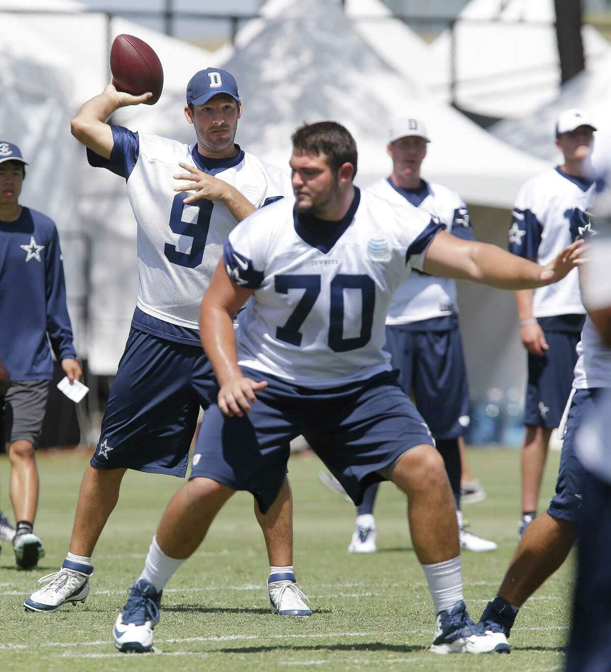 Dallas Cowboys quarterback Tony Romo (9) throws behind rookie offensive lineman Zack Martin during training camp in Oxnard, Calif., on Friday, July 25, 2014. (Ron T. Ennis/Fort Worth Star-Telegram/MCT)
