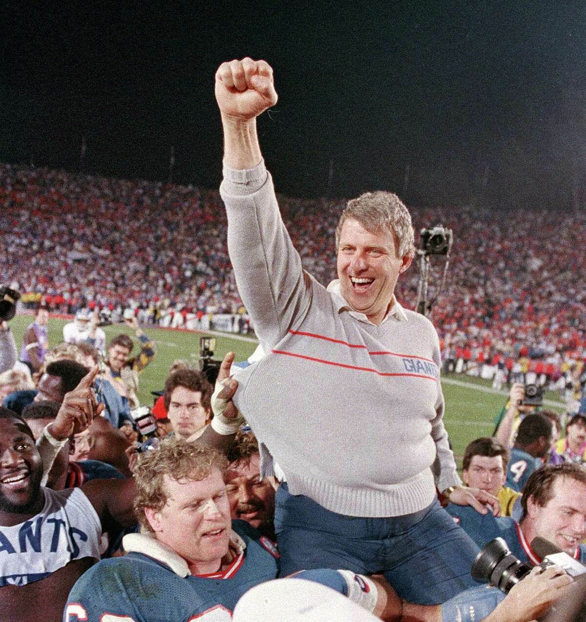 FILE - In this Jan. 25, 1987, file photo, New York Giants coach Bill Parcells is carried off the field after the Giants defeated the Denver Broncos, 39-20, in Super Bowl XXI in Pasadena, Ca. Parcells will enter the Pro Football Hall of Fame in Canton, Ohio, Sunday, Aug. 4, 2013. (AP Photo/Eric Risberg, File) ORG XMIT: NYR104