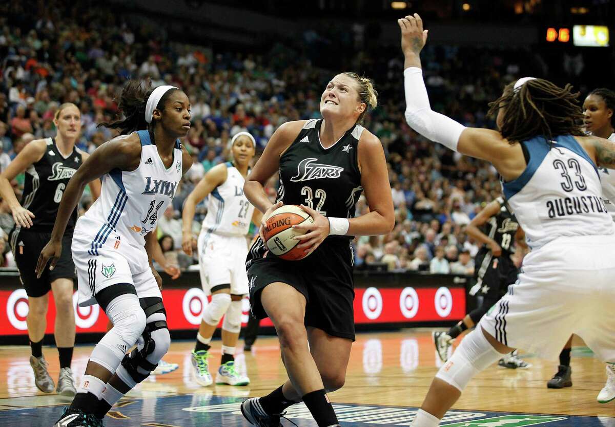San Antonio Silver Stars center Jayne Appel (32) looks up to the basket against the defense of Minnesota Lynx forward Devereaux Peters (14) and guard Seimone Augustus (33) in the second half of a WNBA basketball game, Friday, August 2, 2013, in Minneapolis. The Lynx won 85-63. (AP Photo/Stacy Bengs)