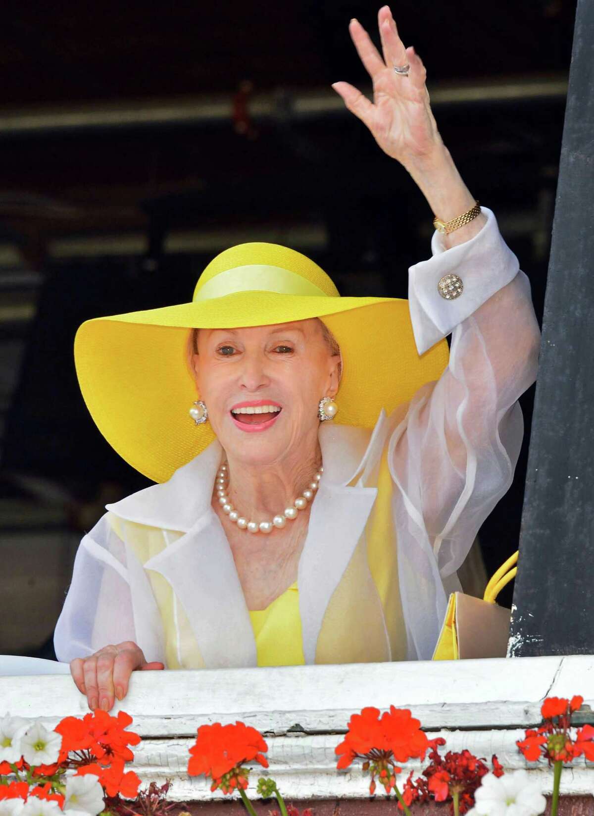 Marylou Whitney waves to fans at Saratoga Race Course Saturday Aug. 3, 2013, in Saratoga Springs, NY. (John Carl D'Annibale / Times Union)
