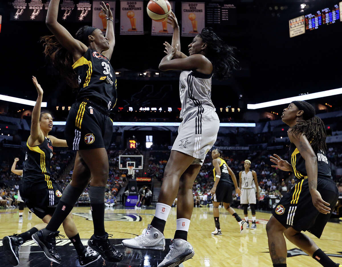 Silver Stars' Shameka Christon passes between the Shock's Tiffany Jackson-Jones (left) and Roneeka Hodges during second half action Sunday Aug. 4, 2013 at the AT&T Center. The Silver Stars won 69-65.